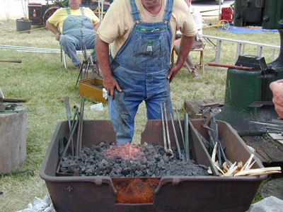 At the forge, waiting for the metal to heat.