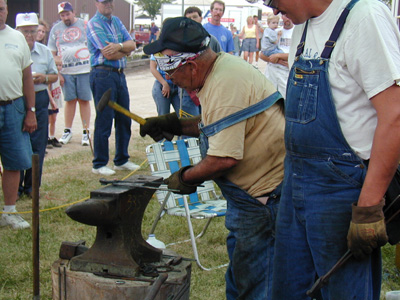 Heading the rivet to assemble the tongs.